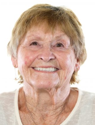 Headshot of a woman in a white shirt