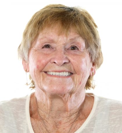 Headshot of a woman in a white shirt